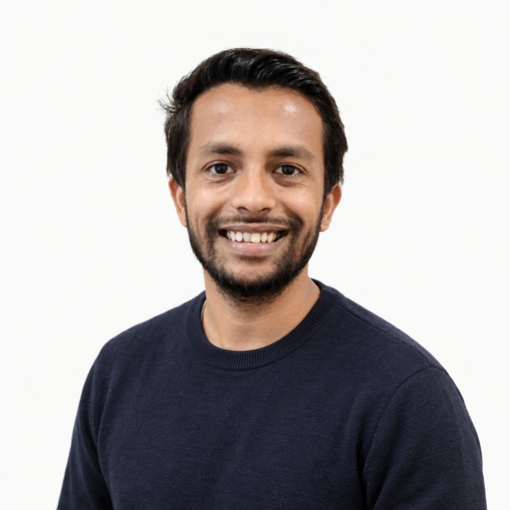 Studio portrait of Mamun Ahmed, smiling, facing the camera.